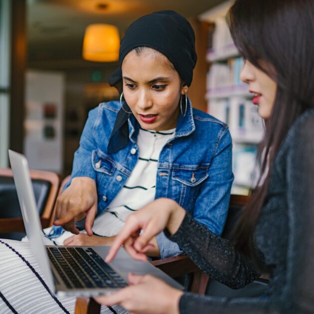 Fractional CFO Two women working around a laptop