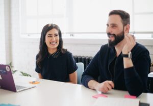 Woman and man smiling at work