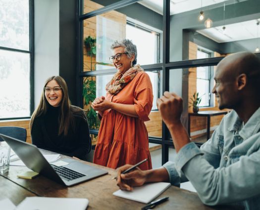 Diverse businesspeople smiling cheerfully during a meeting in a modern office. Group of successful businesspeople working as a team in a multicultural workplace.